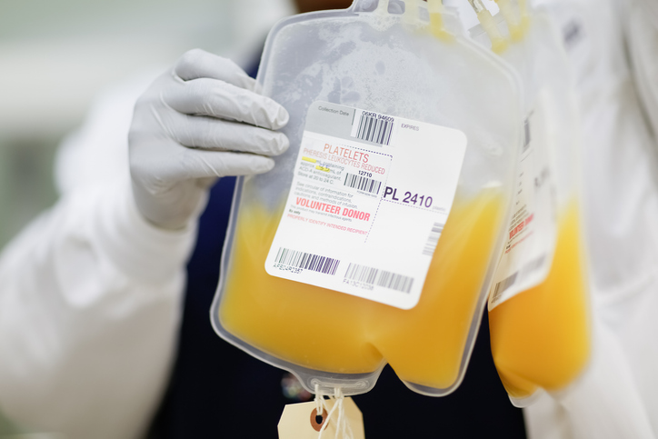 Photo shows an unidentified person holding up a donor's platelet donation at a public blood drive in Torrance, CA/Getty Images