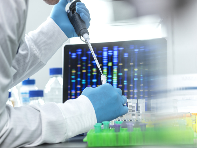 Photo shows a scientist pipetting a sample into a vial for DNA testing/Getty Images