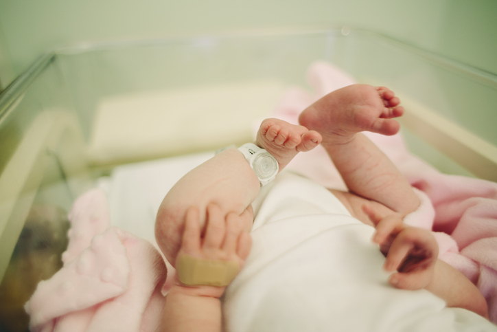 Photo shows a baby's feet with a hospital security tag on/Getty Images