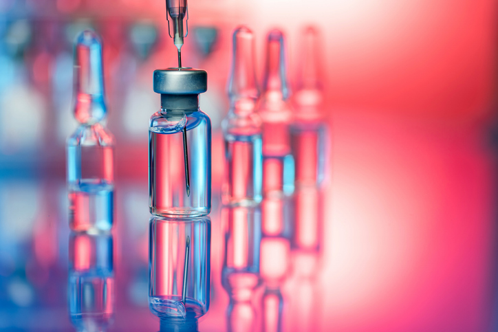 Photo shows a close up shot of glass bottles, ampules and syringe with needle/Getty Images