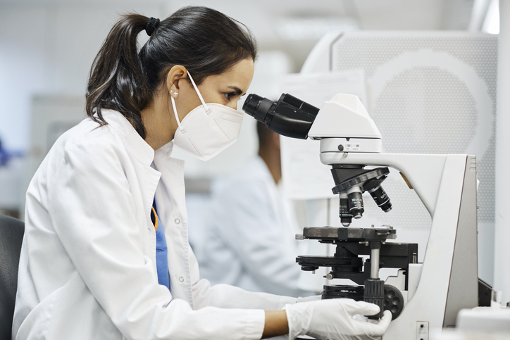 Photo shows a woman conducting research in a lab/Getty Images