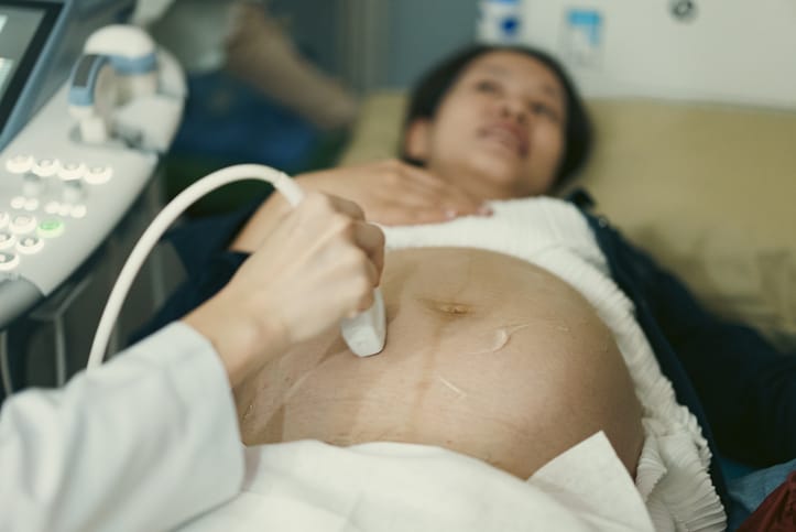 Photo shows a pregnant woman getting an ultrasound at the doctor's office/Getty Images